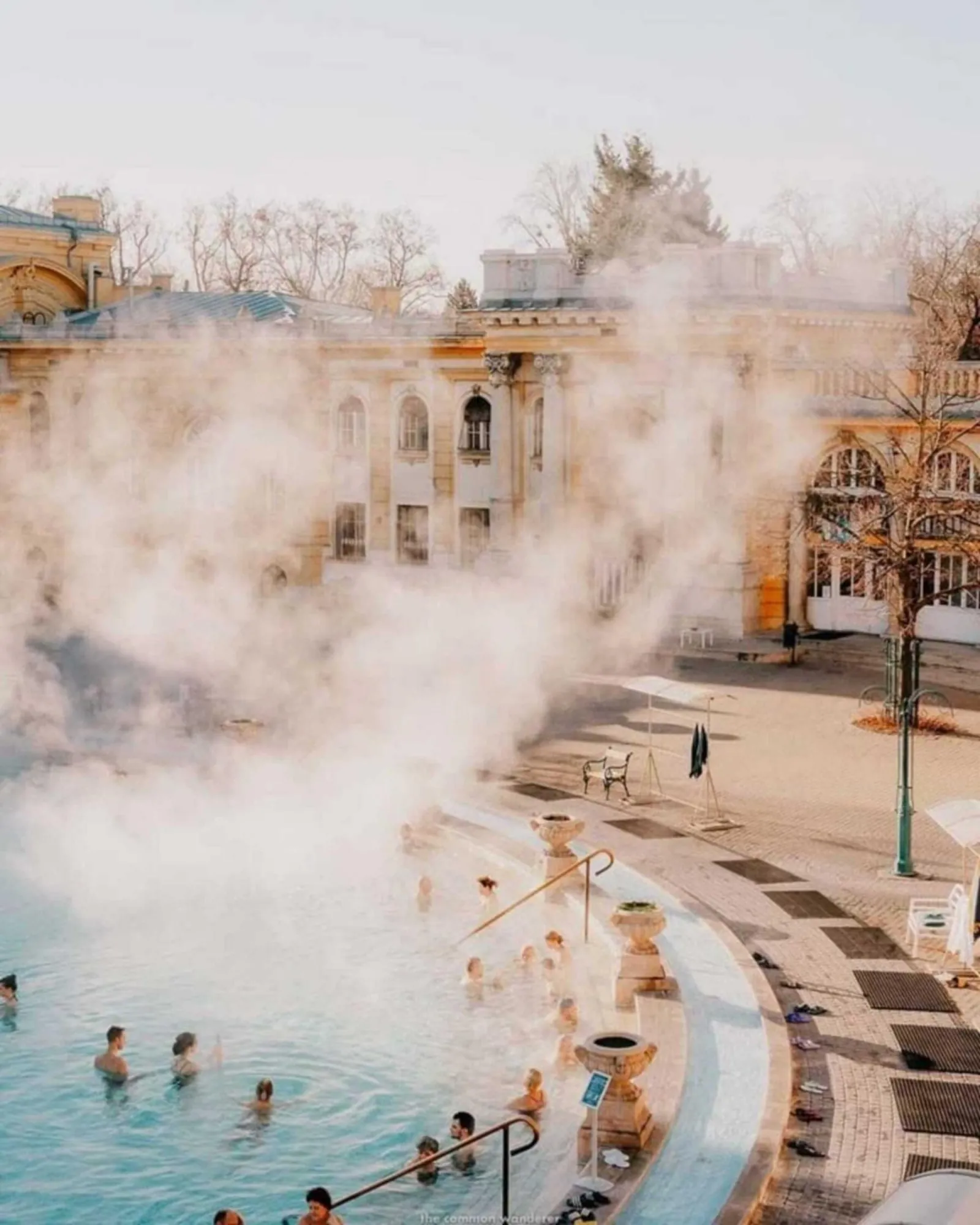 Steam rising from Széchenyi's outdoor thermal pool on a cold winter morning