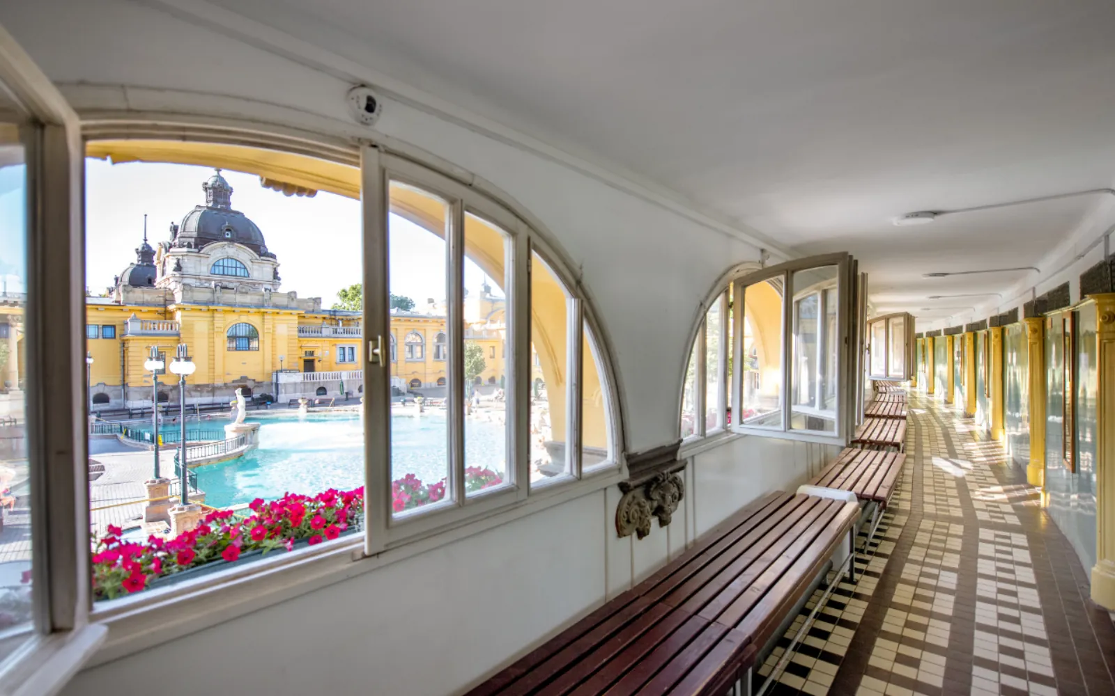 Arched windows of a Széchenyi corridor looking out over the outdoor pools