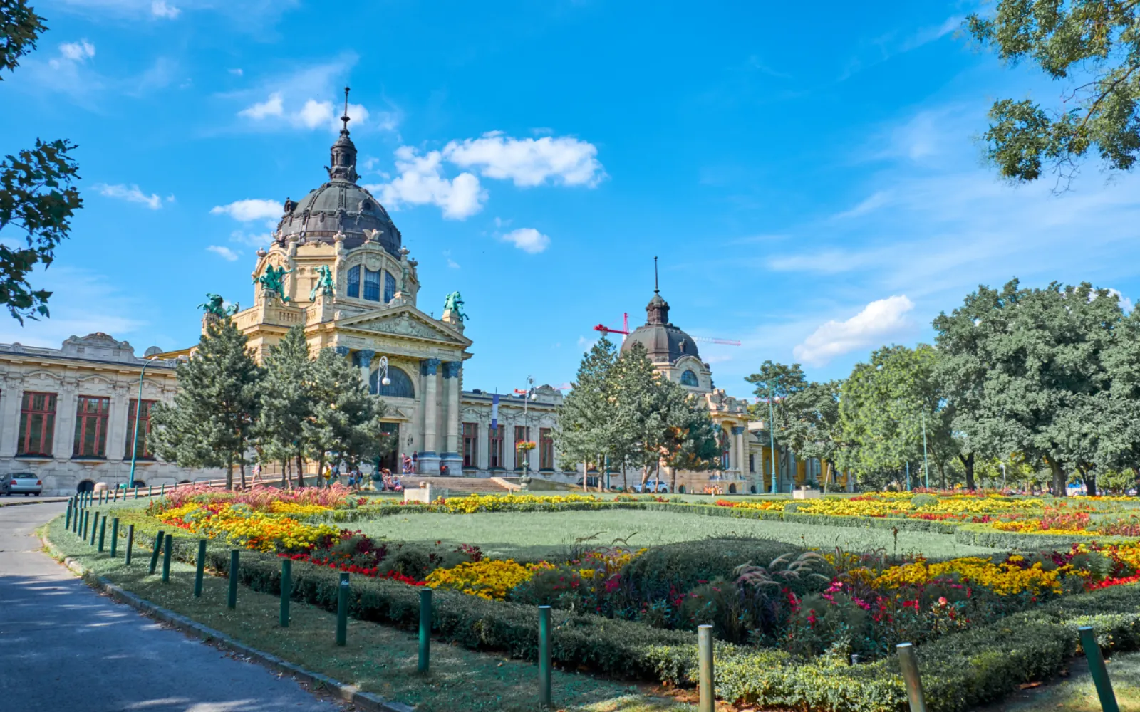 Széchenyi Bath's domed main entrance behind City Park flowerbeds