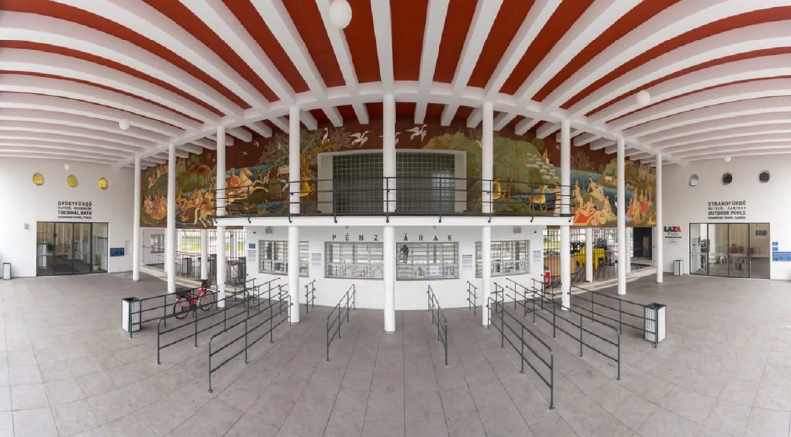 Palatinus entrance hall with a red and white striped ceiling, a mural and ticket windows