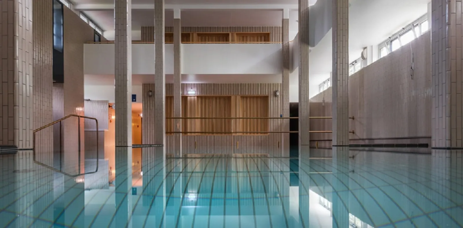 Indoor thermal pool at Palatinus with tiled columns and still turquoise water