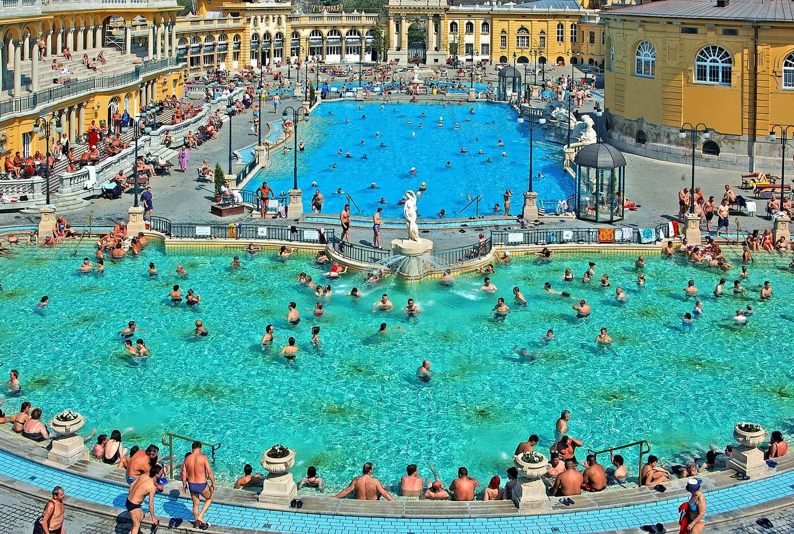 Aerial view of Széchenyi's crowded outdoor pools on a sunny day
